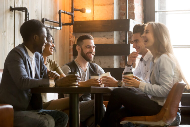 Multiracial,Friends,Having,Fun,And,Laughing,Drinking,Coffee,In,Coffeehouse,