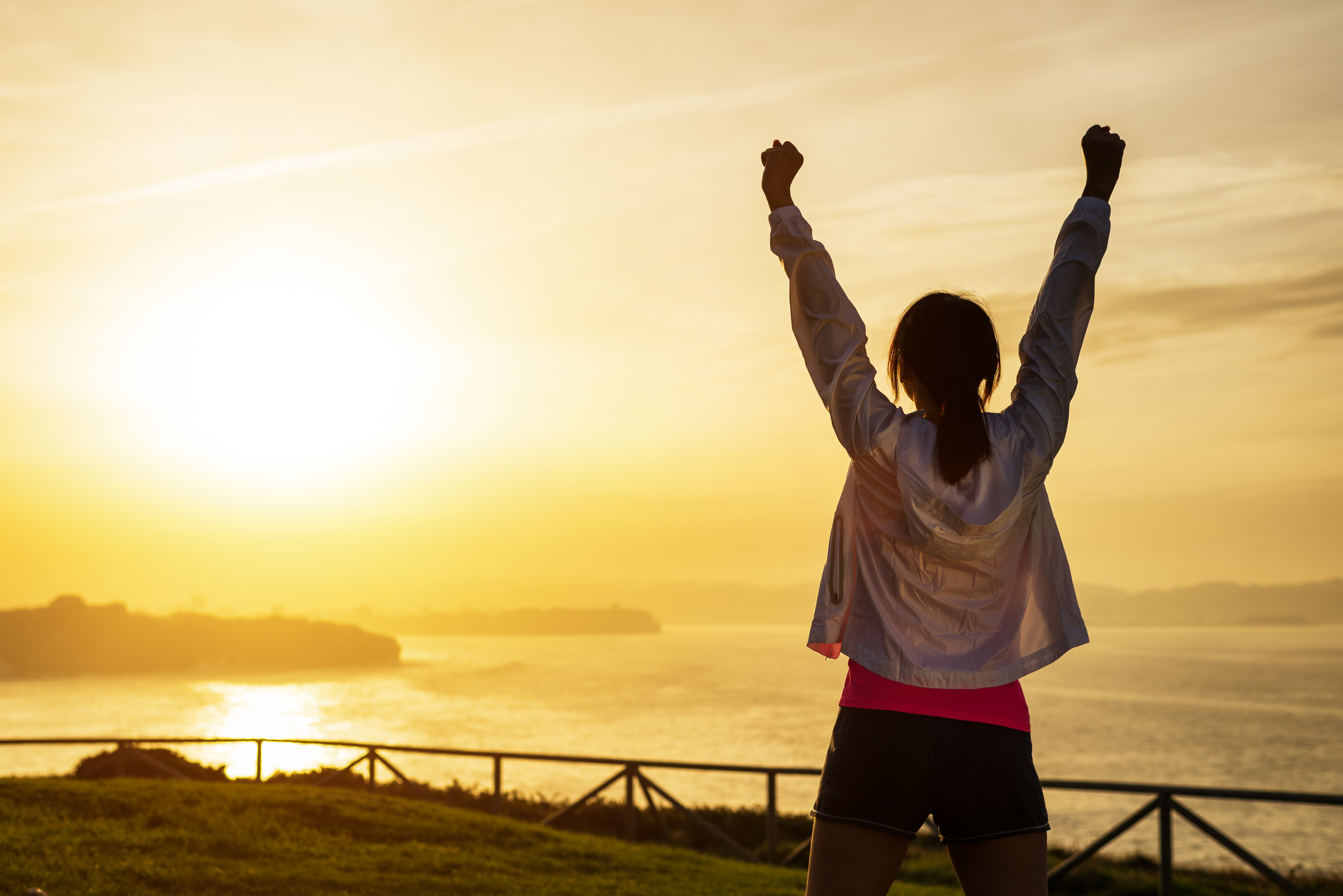 Successful,Sporty,Woman,Raising,Arms,Towards,Golden,Beautiful,Sunset,And